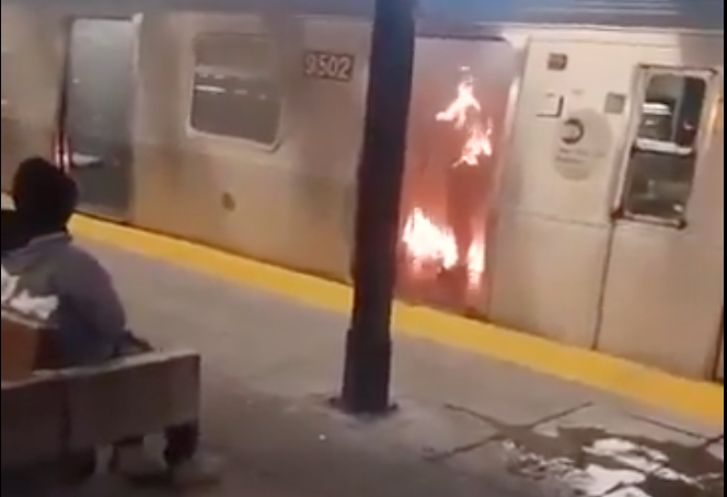 The suspect sat on a platform bench and watched the victim, who was conscious and standing upright, burn.